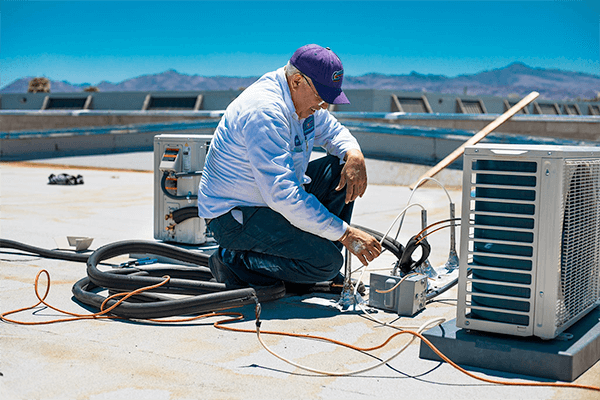 AC Technician Repairing Air Conditioner